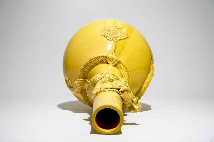 A tall Japanese Awaji monochrome yellow vase with applied dragon design, Meiji, late 19th C.