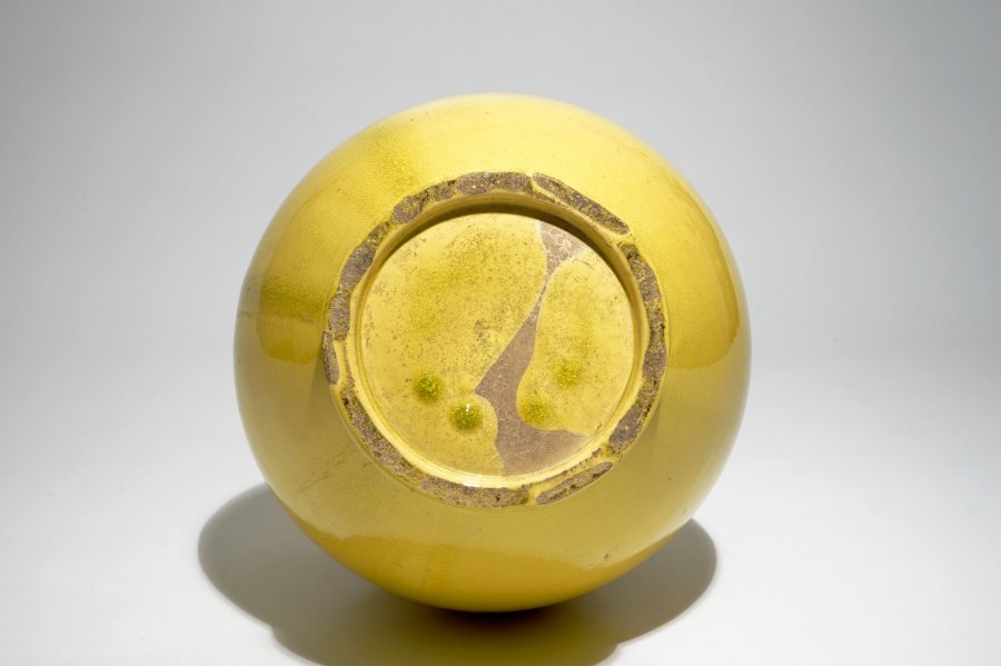A tall Japanese Awaji monochrome yellow vase with applied dragon design, Meiji, late 19th C.